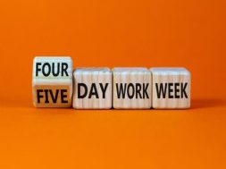 4 or 5 day work week symbol. Turned the cube and changed words ‘five day work week’ to ‘four day work week’. Beautiful orange background. Copy space. Business and 4 or 5 day work week concept.