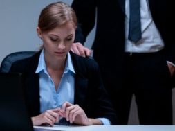 Workplace-sexual-harassment-man-hovers-behind-woman-e1600874742279-700×407