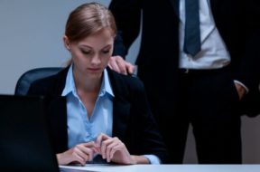 Workplace-sexual-harassment-man-hovers-behind-woman-e1600874742279-700×407